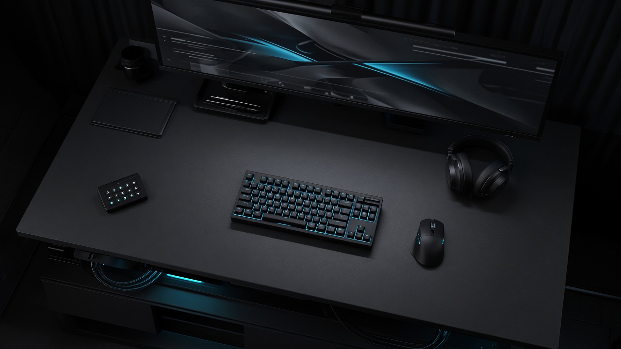 Competitive desk with keyboard, mouse, headset, and a wide monitor